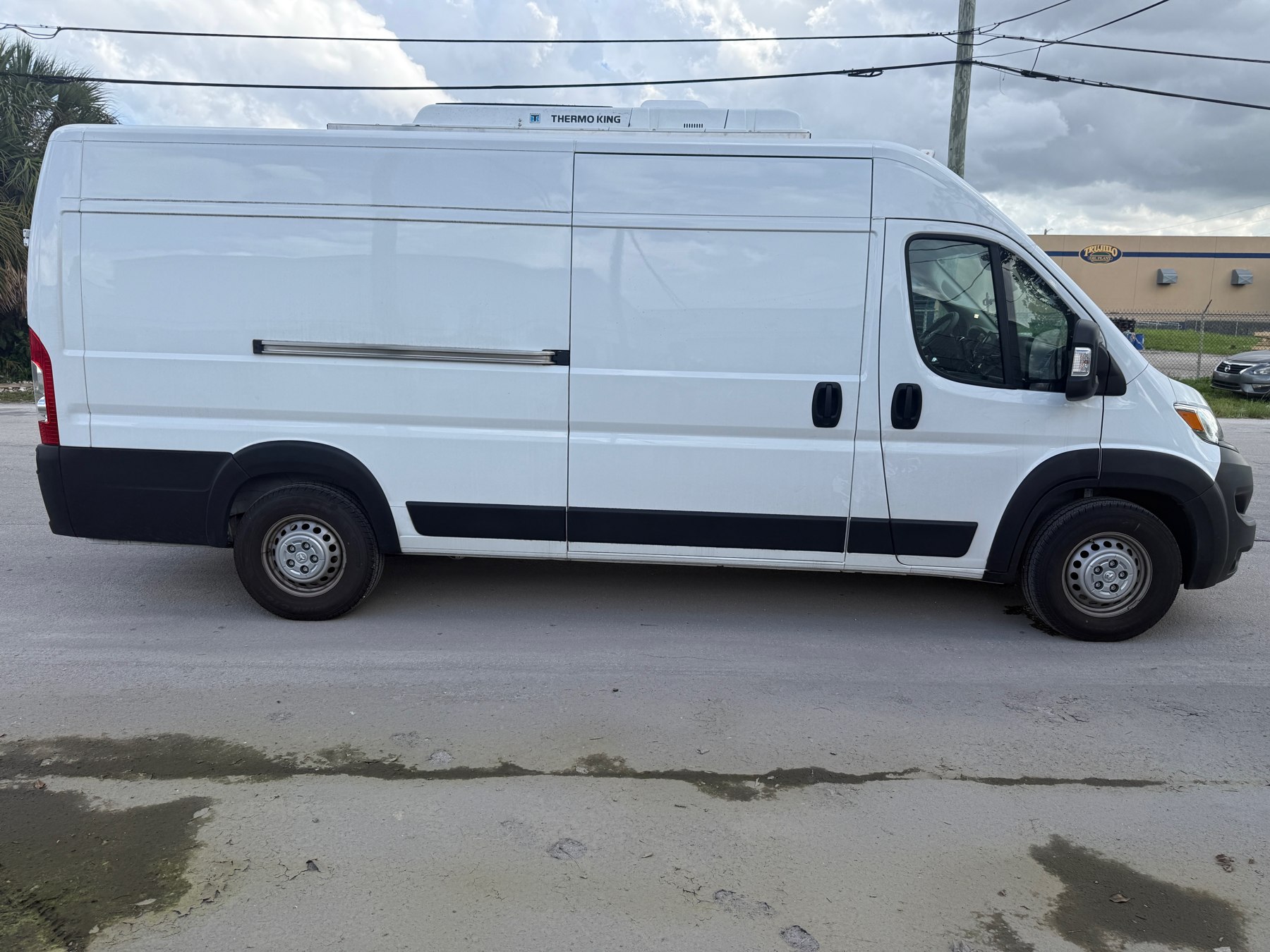 White cargo van with a roof-mounted Thermo King refrigeration unit